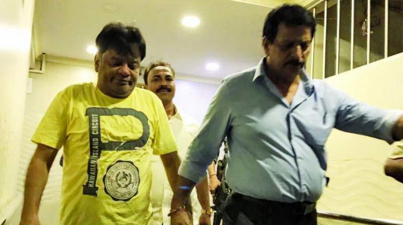 The Thane police on Monday evening arrested gangster Dawood Ibrahims brother Iqbal Kaskar (yellow T-shirt) in connection with an extortion case.