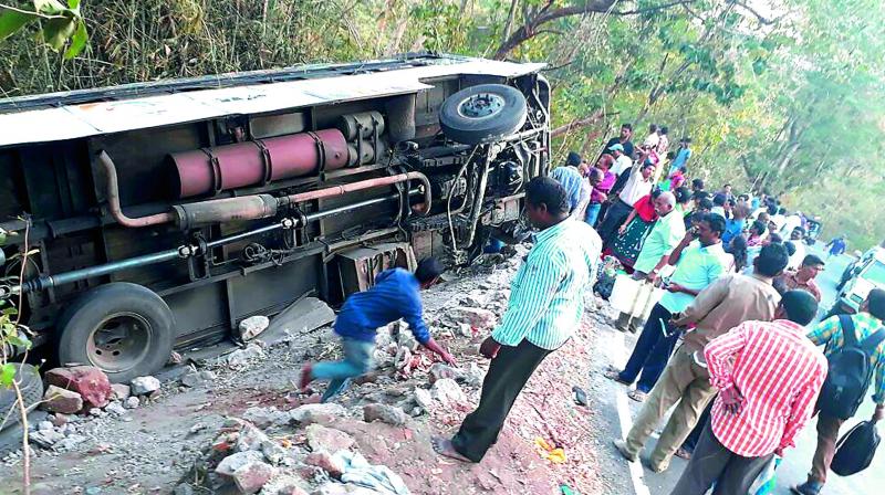 A bus overturned at Paderu ghat road due to breaks failure in Visakhapatnam on Wednesday.