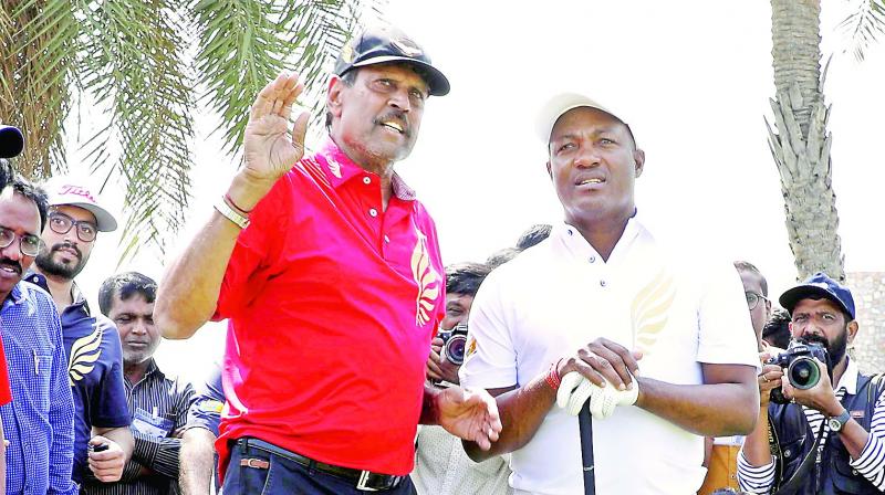 Former cricketers turned golfers Kapil Dev (left) and Brian Lara in action at the Golden Eagles Golf Championship in Hyderabad on Saturday.  (Surendra P.)