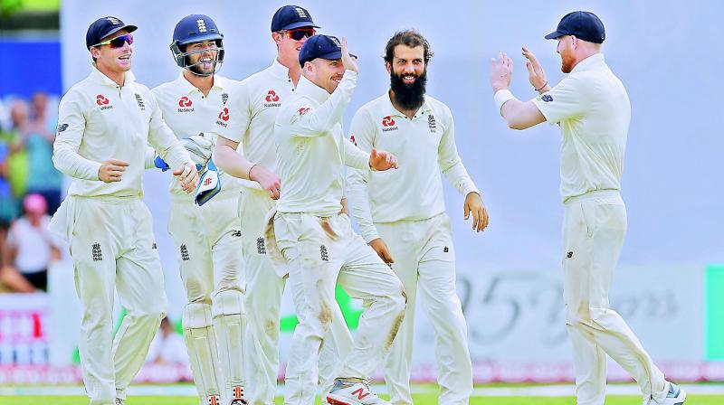 England players celebrate a Sri Lankan wicket in the first Test. (Photo: AP)