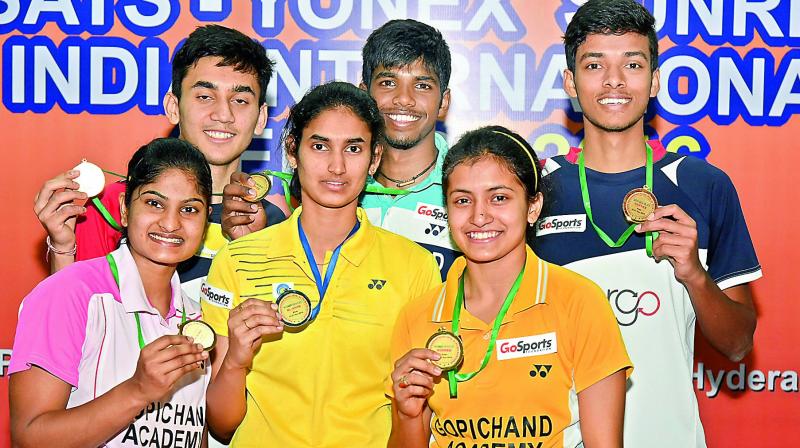 K. Maneesha (from left), Lakshya Sen, Ruthvika Shivani,  Satwiksairaj Rankireddy, Rituparna Das and Chirag Shetty are all smiles as they pose with their medals from the International Badminton Series.(Photo: R. Pavan)