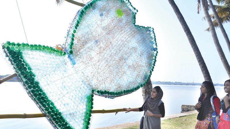 Representative image: students observe an installation made of plastic bottles.