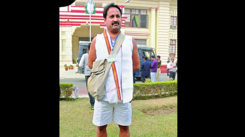 BJP MLA Vinay Bihari, who was prevented from entering the Assembly due to inappropriate attire, outside Bihar Assembly in Patna on Monday. (Photo: PTI)