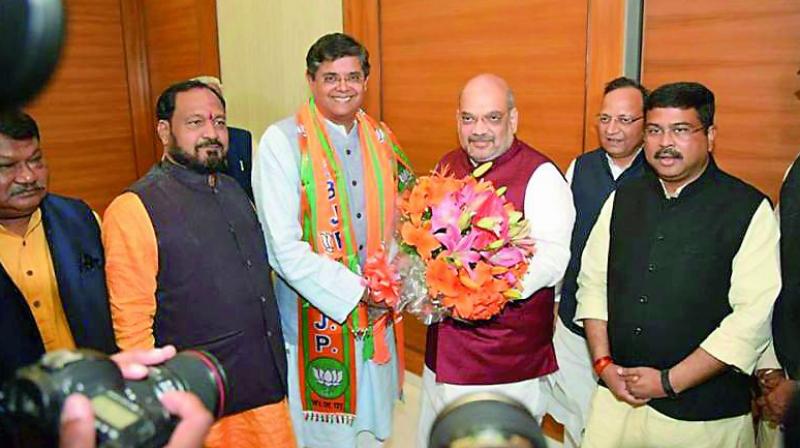 BJP national president Amit Shah welcomes Jay Panda to the party fold on Monday.