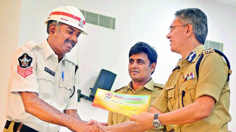 Commissioner of police D. Gautam Sawang distributes certificates to traffic constables in Vijayawada on Saturday. (Photo: DC)