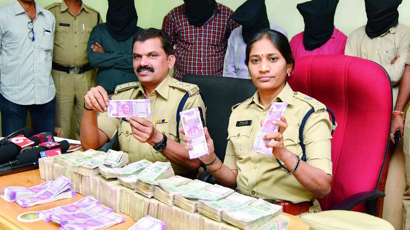DCP B. Sumathi shows the cash seized from the men who robbed a businessman at Bollarum.