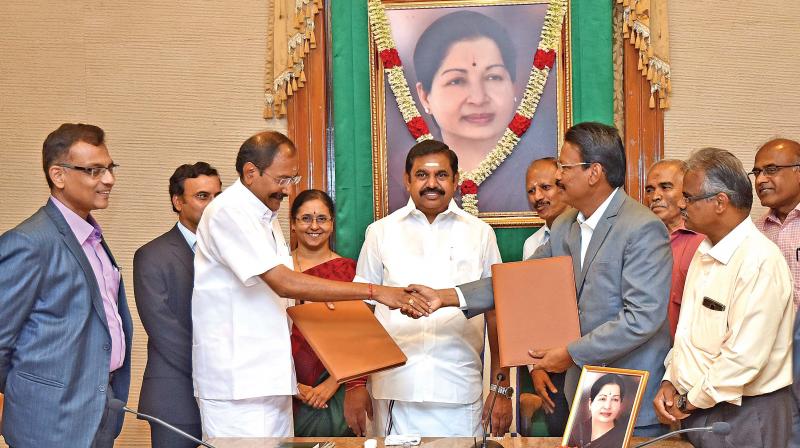 Power minister P. Thangamani shakes hands after signing the MoU with four firms for solar power generation in the presence of Chief Minister Edappadi K. Palaniswami on Tuesday.(Photo: DC)