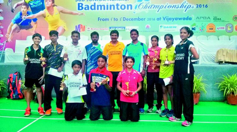 Winners and runners-up in various categories pose with their trophies at the 30th Sub-Junior national badminton championships played at Vijayawada.