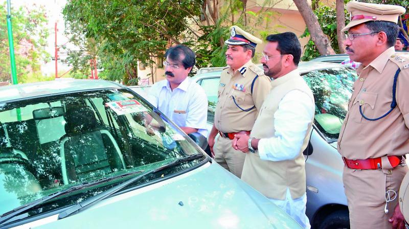 A cab registration sticker being affixed on a cab at the LB Nagar cab registration booth on Monday. (Photo: DC)