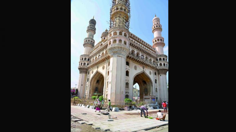 Tiles being laid around the Charminar at Hyderabad on Monday. (Photo: DC)