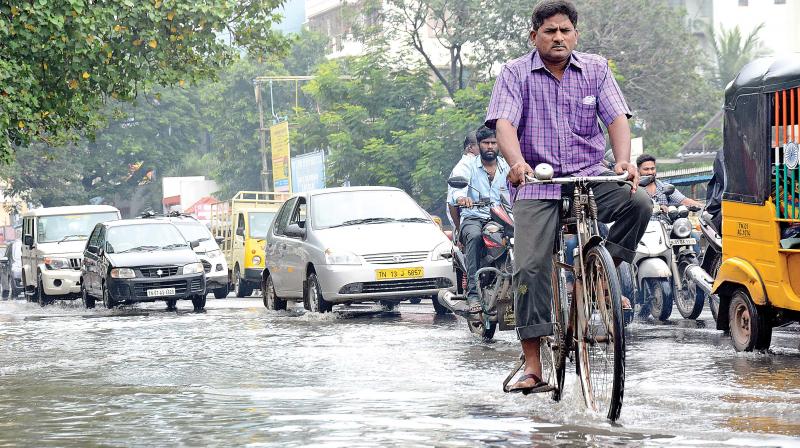 Motorists struggle to ride through waterlogged Flowers road at Kilpauk on Monday. Sewage is also mixed with rainwater.  (Photo: DC)