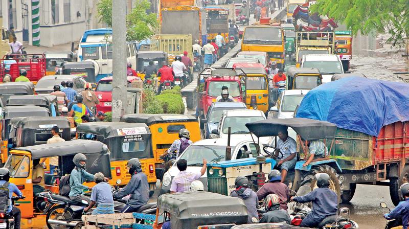 Due to showers, water stagnation creates traffic snarls at Thattankulam, Choolai, on Monday. (Photo: DC)
