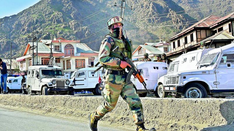 An Army soldier arrives at the site where militants attacked a CRPF convoy on the outskirts of Srinagar along Srinagar-Jammu national highway on Monday. (Photo: PTI)