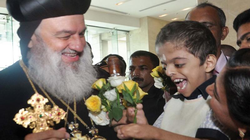Patriarch of the Syrian Orthodox Church Igantius Aphrem II accepting a floral welcome by special children of Centre for Empowerment and Enrichment in Kochi on Tuesday.  (Photo: SUNOJ NINAN MATHEW)