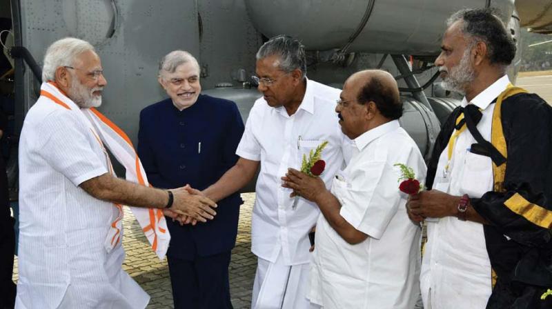 Chief Minister Pinarayi Vijayan greets Prime Minister Narendra Modi on his arrival at Ashramam helipad in Kollam on Tuesday. Governor P. Sathasivam, PWD Minister G. Sudhakaran and Mayor V. Rajendra Babu look on.