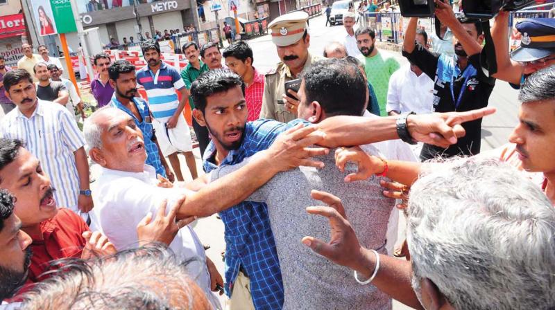 BJP workers clash with police in Kottayam on Sunday. They also attacked mediapersons for  covering the violence. (Photo: RAJEEV PRASAD)