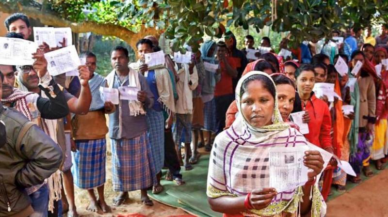 Voters wait in queues to cast their votes during the first phase of Assembly elections in Chhattisgarh at a polling station in Narayanpur. (Photo: PTI)