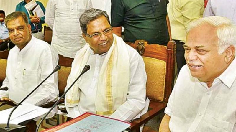 Chief Minister Siddaramaiah, former revenue minister and BJP candidate for Nanjangud Assembly seat V. Srinivasprasad and industries minister R.V. Deshpande in a file photo