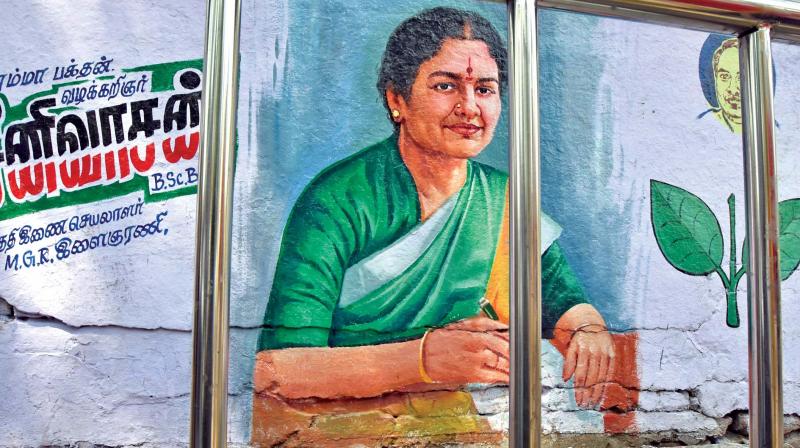 When looking through the railings, this poster on the wall appears to show Sasikala is behind bars near Poes Garden on Tuesday. (Photo: N. Sampath)