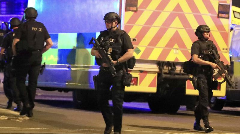 Armed police respond after reports of an explosion at Manchester Arena during an Ariana Grande concert in Manchester, England. (Photo: AP)