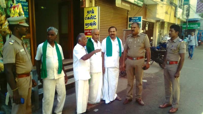 Police arrested members of the Tamil Nadu Toddy Movement for offering toddy  bottles as padayal to the Mahatma Gandhi  statue, on Tuesday. 	 	Image: DC