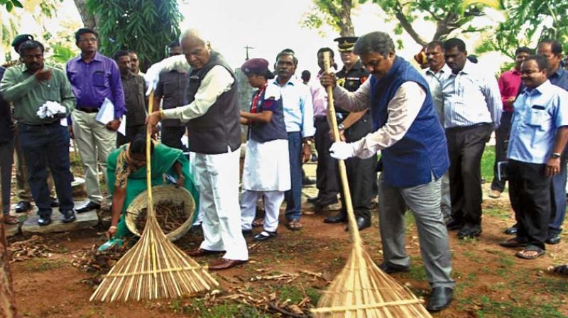 Governor Banwarilal Purohit launches a mass cleaning drive in Raj Bhavan, on Tuesday. R. Rajagopal, Additional Chief Secretary to Governor, officers, staff and students take part in the cleaning drive.   ( Image: DC )