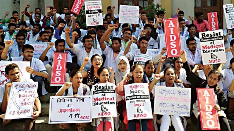 Students from government medical colleges protest against the proposed increase in fees and NRI quota in Bengaluru on Friday	 DC