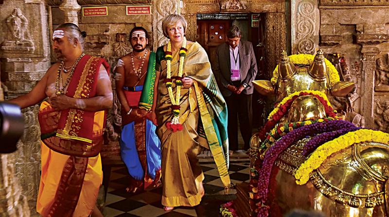 Theresa May during her visit to the Someshwara Temple In Bengaluru on Tuesday; (right) Garbage dumped on Ulsoor Road reappeared on Tuesday evening (Photo: R.Samuel)