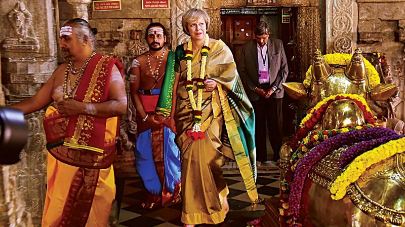 Theresa May during her visit to the Someshwara Temple In Bengaluru on Tuesday; (right) Garbage dumped on Ulsoor Road reappeared on Tuesday evening (Photo: R.Samuel)