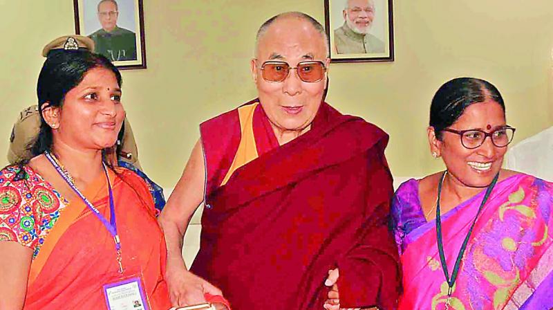 The Dalai Lama, the spiritual leader of the Tibetan Buddhists, with the organisers of National Womens Parliament in Vijayawada on Thursday. 	(Photo: DC)