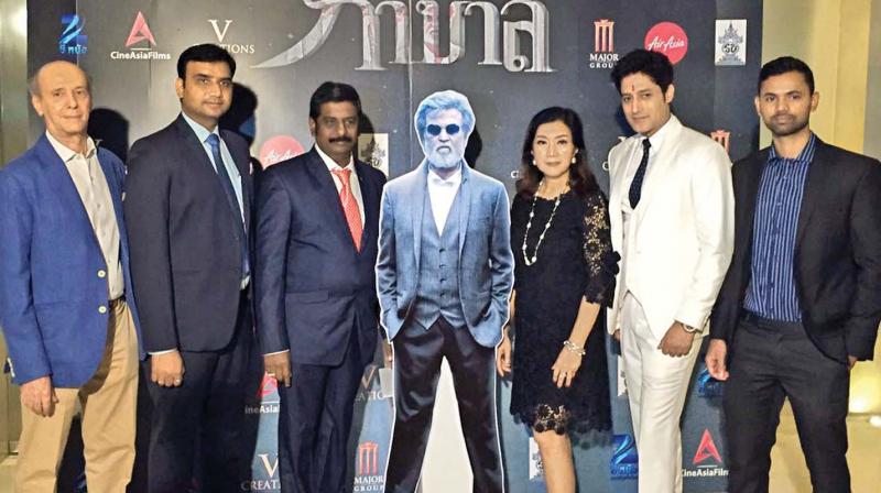 Parandhaman Thanu (left to Kabali standee) at an event in Thailand.