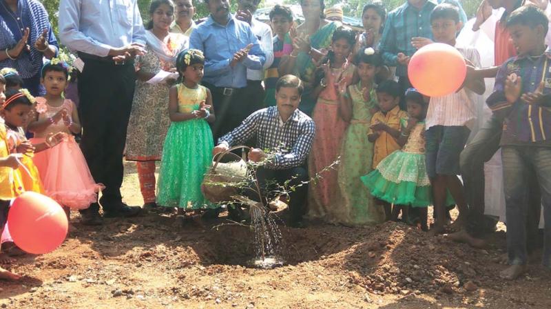 Madurai collector Veera Raghava Rao plants a family tree in remembrance of Aysushi who was given for adoption to childless couple at Claretian Mercy Home located in Azhagusirai  village near Madurai on Sunday (Photo: DC)