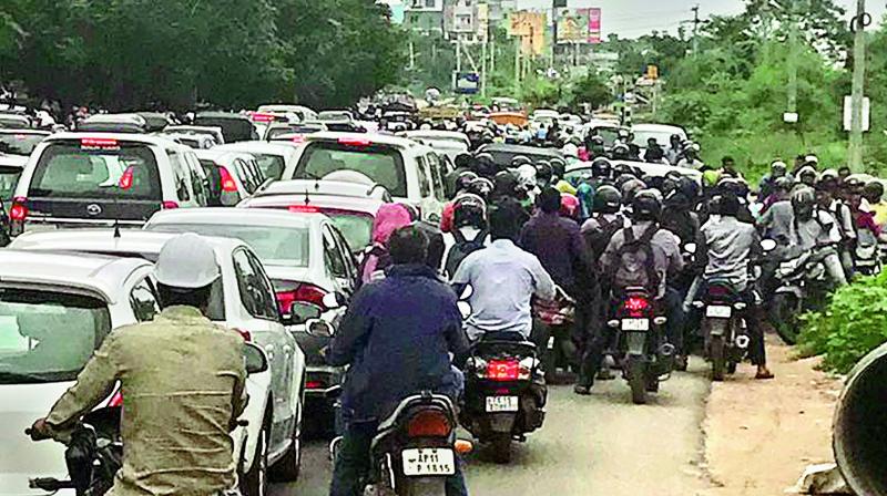 Vehicles are caught in a traffic jam at the Wipro-IIIT junction.
