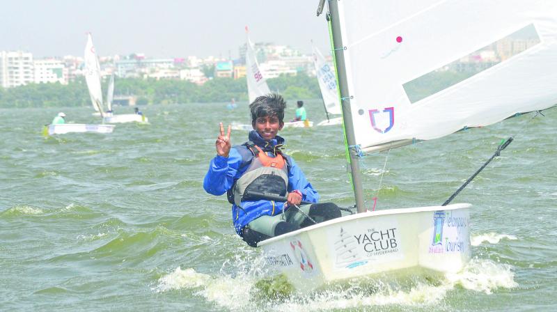 Young sailor from Telangana, Durga Prasad flashes a victory sign after finishing on top to lift the TSA State Championship trophy in the Telangana State Sub-Junior Sailing Championships in Hussainsagar lake.