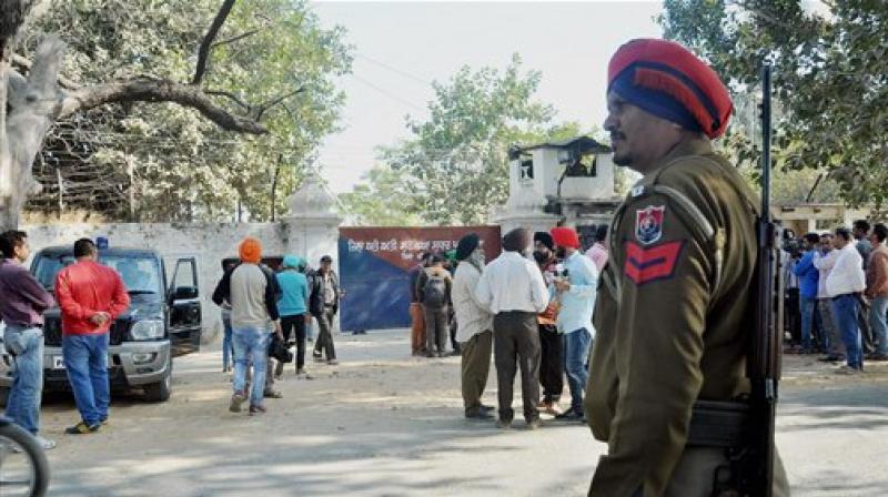 Security personnel and media outside Nabha Central Jail, which was stormed by armed men who helped in escaping five terrorists including Khalistan Liberation Front chief Harminder Mintoo. (Photo: PTI)