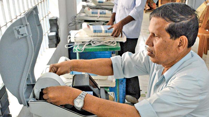 Poll officials check the voter-verified paper audit trail machines to be used for RK Nagar election at Pulianthope corporation school. (Photo: DC)