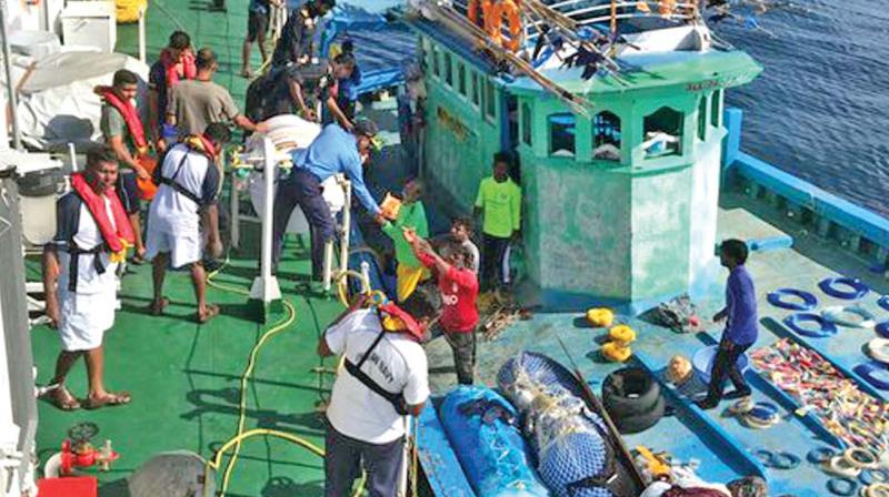 A photo released by the Indian Coast Guard shows its ship  rescuing Kanyakumari  fishermen off Kochi on Wednesday.