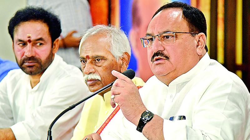 Union minister and Telangana State election BJP incharge Jagat Prakash Nadda speaks to the media at the BJP state office in Nampally on Monday. MP Bandaru Dattatreya and state BJP chief G. Kishan Reddy are also seen (Photo: S.Surender Reddy)
