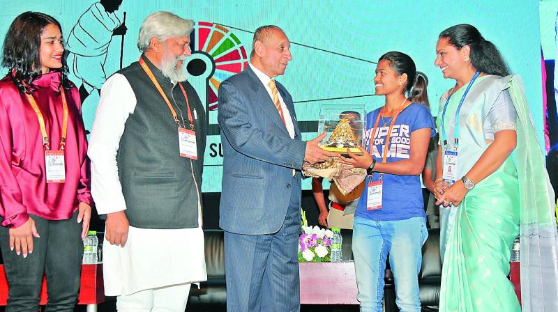 Governor E.S.L. Narasimhan felicitates mountaineer Malavath Purna with the Telangana Jagruthi Young achievers award at the Telangana Jagruthi International Youth Leadership Conference on Sunday. TRS MP  K. Kavitha, wrestler Babita Phogat , Waterman of India Dr Rajendra Singh (second from left) are also seen. The Governor stressed on the importance of the youth and gender equality.	(Photo: P. Surendra)