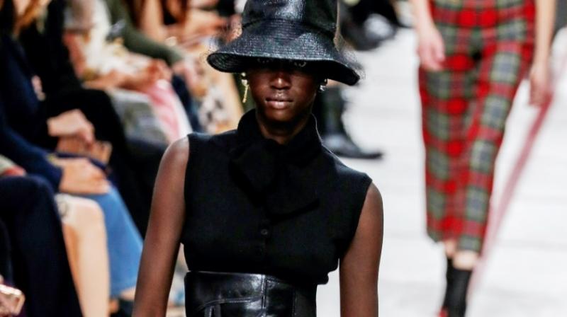 Get ahead... A model wears a bucket hat and leather cumberband at the Diors tartan-heavy Paris autumn winter show. (Photo: AFP)
