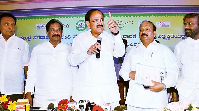 Union Minister Venkaiah Naidu with ministers Roshan Baig and K.J. George in Bengaluru on Tuesday. (Photo: DC)