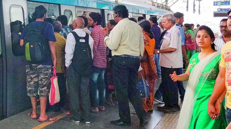 People rush towards metro without letting commuters exit at Ameerpet metro station.  (Photo:DC)