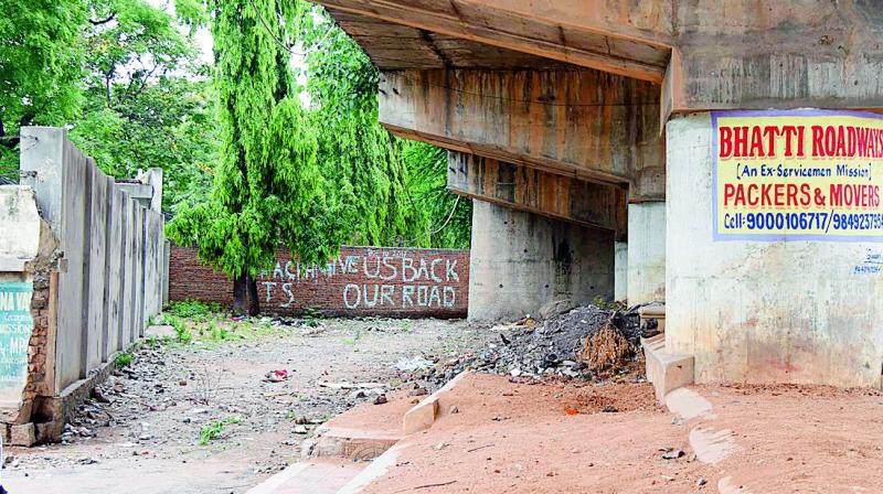 A resident has painted a plaintive message, Give us back our road, on the wall blocking the RK Puram flyover underpass in Secunderabad.  (Photo:DC)