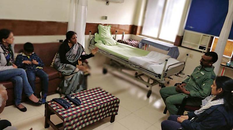 Defence Minister Nirmala Sitharaman meets Wing Commander Abhinandan Varthaman at a hospital in New Delhi on Saturday. His wife Tanvi Marwah, son Tavish and sister Aditi (seated next to the pilot) are also seen