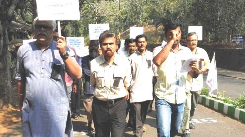 Members of Mahatma Gandhi University Teachers Association take out a protest march on Monday.(Photo: DC)