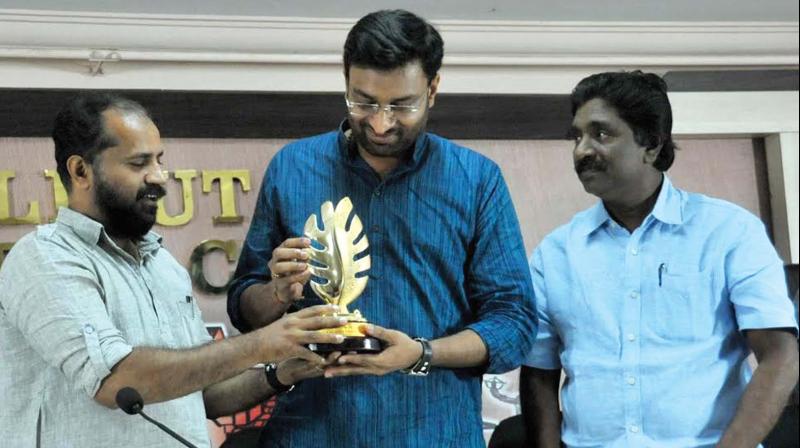 Calicut Press Club president Kamal Varadoor presents a memento to outgoing district collector N. Prasanth, while secretary N. Rajesh looks on at the Calicut Press Club on Monday. (Photo: Venugopal)