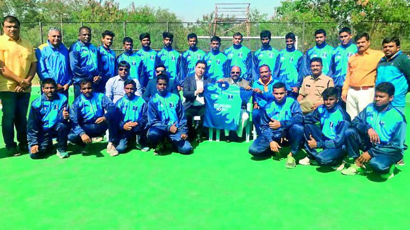 Members of the Telangana hockey team pose in Hyderabad after receiving their kits for the upcoming National Championships to be held in Chennai from Friday.