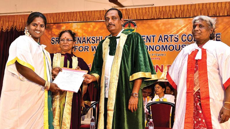 Director of Higher Education (College) Dr Baskaran hands over degree certificates to  students during 42nd convocation of Sri Meenakshi Government Arts College for Women on college premises in Madurai on Friday..(Image DC)