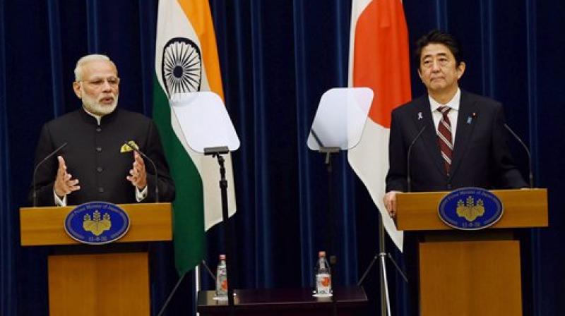 Prime Minister Narendra Modi as his Japanese counterpart Shinzo Abe speaks during their joint statement in Tokyo. (Photo: PTI)