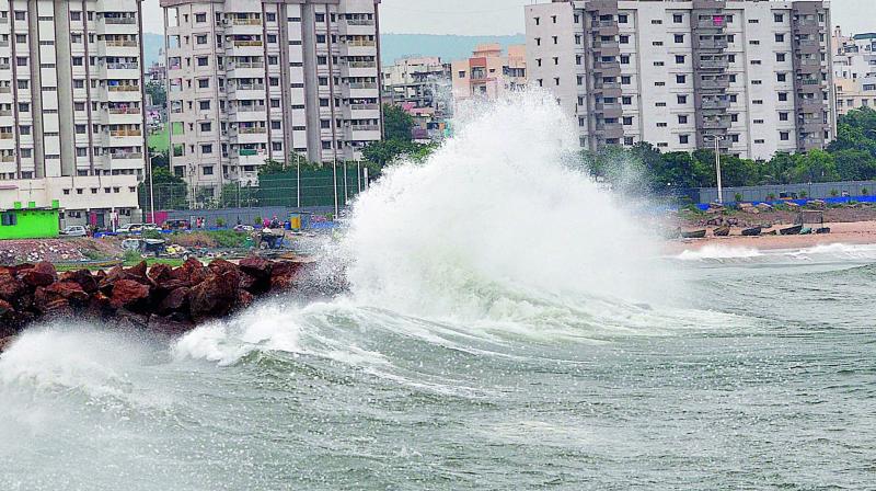 Massive waves are seen during a high tide caused by the approaching cyclone Titli, in Visakhapatnam on Wednesday. 	    Image: P Narasimha Murthy